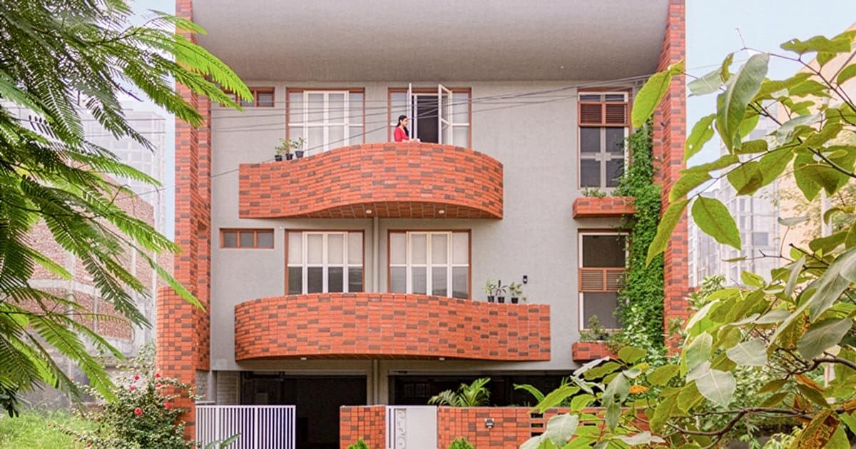 curved balconies clad in brick tiles outline a multi-generational indian home